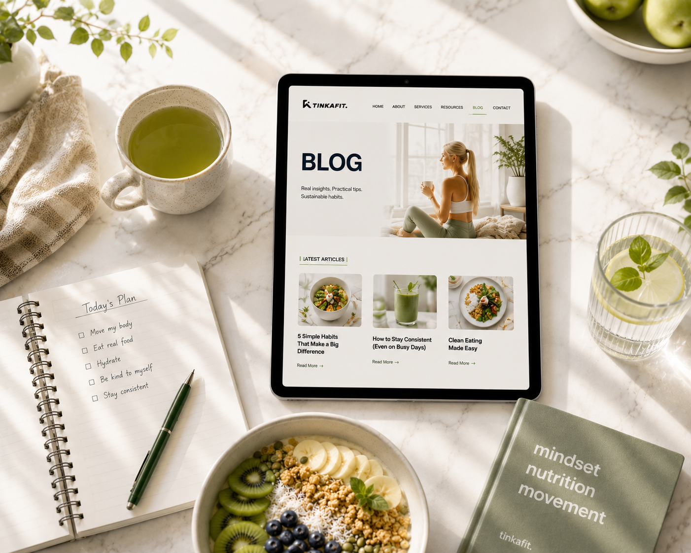 TINKAFIT blog displayed on a tablet with wellness planning essentials